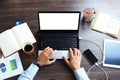 Vintage hipster wooden desktop top view, male hands using laptop Royalty Free Stock Photo