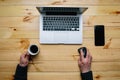 Vintage hipster wooden desktop top view, male hands using a laptop Royalty Free Stock Photo