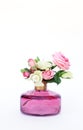 Vintage home decor. Flowers in pink glass bottle vase isolated on white background Royalty Free Stock Photo