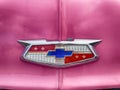 Vintage Hood Emblem On A Pink Car