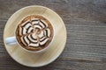 Vintage hot coffee cup with nice Latte art decoration on old woo