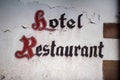 Vintage Hotel and Restaurant signage in gothic script writing typeface