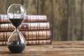 Vintage hourglass against a stack of old books Royalty Free Stock Photo