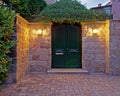 Vintage house entrance dark green door late in the afternoon