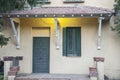 Vintage house entrance with a green door and window with a beautiful porch lightning in the centre of Madrid city. Royalty Free Stock Photo