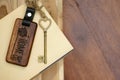 Vintage house key with wooden home keyring on wood board background, property concept, copy space Royalty Free Stock Photo