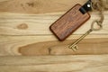 Vintage house key with wooden home keyring on wood board background, property concept, copy space Royalty Free Stock Photo