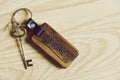 Vintage house keys and wood home keychain on wooden table background, key concept Royalty Free Stock Photo