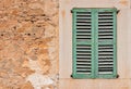 Vintage house with old green window wood shutter and grunge wall Royalty Free Stock Photo