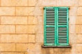 Vintage house wall with old green wood window shutter Royalty Free Stock Photo
