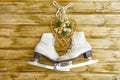 Vintage ice skates for figure skating with fir tree branch hanging on rustic background. Christmas decoration.