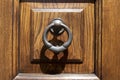 Vintage image of ancient door knocker on a wooden door Royalty Free Stock Photo