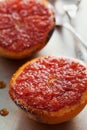 Vintage image of broiled grapefruit with brown sugar and cinnamon on metal surface, healthy dessert is good for breakfast Royalty Free Stock Photo