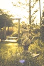 Vintage  image of countryside garden with water well in rustic village Royalty Free Stock Photo