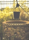 Vintage  image of countryside garden with water well in rustic village Royalty Free Stock Photo