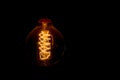 Vintage incandescent light bulb filament on black Royalty Free Stock Photo