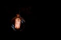 Vintage incandescent light bulb filament on black Royalty Free Stock Photo