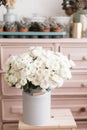 Vintage interior decoration pink pastel closet white roses in metal bucket.