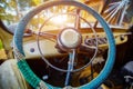 Vintage interior of an old car with a retro dashboard and steering wheel in a PVC cover Royalty Free Stock Photo