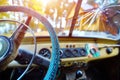 Vintage interior of an old car with a retro dashboard and steering wheel in a PVC cover Royalty Free Stock Photo