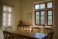 Vintage interior with a red window, a painting in a frame hanging on a wall, and wooden furniture Royalty Free Stock Photo