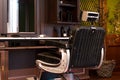 Vintage Interior Of Stylish Barber Shop. Retro Chair And Wooden Table With Trimmer And Fan. 3d Rendering