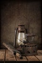 Vintage items kerosene lamp, iron old iron, washing board on a wooden table and art background. Royalty Free Stock Photo