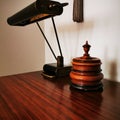 Antique table lamp and tobacco jar on the table.