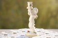 vintage items, white porcelain figurine, candlestick Small cupid of Love with golden wings, angel miniature and soft light against Royalty Free Stock Photo