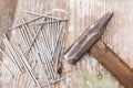 Vintage joiner hammer and nails hobnails lying on old wooden table or workbench with splashes paint on it. Tool master carpenter