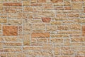 Vintage kasota limestone brick wall texture in colors of orange and pink beige Royalty Free Stock Photo