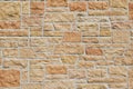 Vintage kasota limestone brick wall texture in colors of orange and pink beige Royalty Free Stock Photo