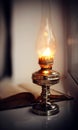 Vintage kerosene lamp and old open book Royalty Free Stock Photo