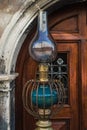 Vintage kerosene lamp . Old austran doors on background Royalty Free Stock Photo