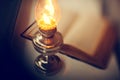 Vintage kerosene lamp and old open book Royalty Free Stock Photo