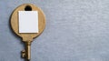 Vintage Key with Blank Tag on a Textured Gray Background Royalty Free Stock Photo