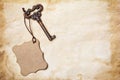 Vintage key with mockup empty tag on yellowed paper Royalty Free Stock Photo