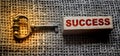 Vintage Key and success word on wooden block on burlap canvas. Key to success concept Royalty Free Stock Photo