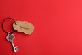 Vintage key with tag on red background, top view and space for text. Keyword concept Royalty Free Stock Photo