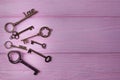 Vintage keys collection. Key Love and key Dream on the pink wooden background. Top view, free space