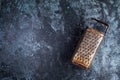 Vintage kitchen grater on a blue grundge background Royalty Free Stock Photo