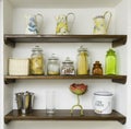 Vintage kitchen shelves with jars, jugs and pots Royalty Free Stock Photo