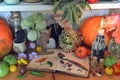 Vintage kitchen still life with old cook book, burning candle, pumpkin, spice, vegetables Royalty Free Stock Photo