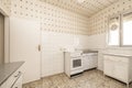 Vintage kitchen with white tiles on the wall, ceiling with decorative paper