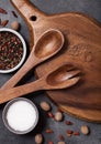 Vintage kitchen wooden utensils with chopping board on stone table background. Top view. Salt and pepper. Royalty Free Stock Photo