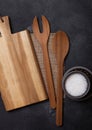 Vintage kitchen wooden utensils with chopping board on stone table background. Top view. Salt and pepper. Royalty Free Stock Photo