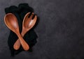 Vintage kitchen wooden utensils over black cloth on stone table background. Top view. Space for text Royalty Free Stock Photo