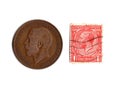 Vintage Kng George V one penny coin and postage stamp from the United Kingdom.