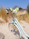 Vintage ladies bike with flowers at the beach