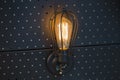 Vintage lamp Edison bulb, wall lamp on a black metal panel Royalty Free Stock Photo